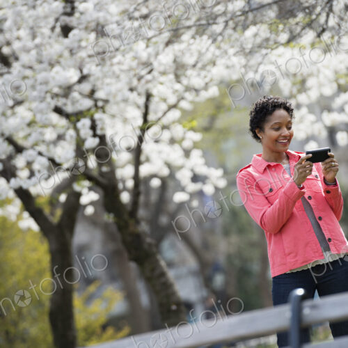Outdoors in the city in spring time. New York City park. White blossom on the trees. A… Outdoors in the city in spring time. New York City park. White blossom on the trees. A…