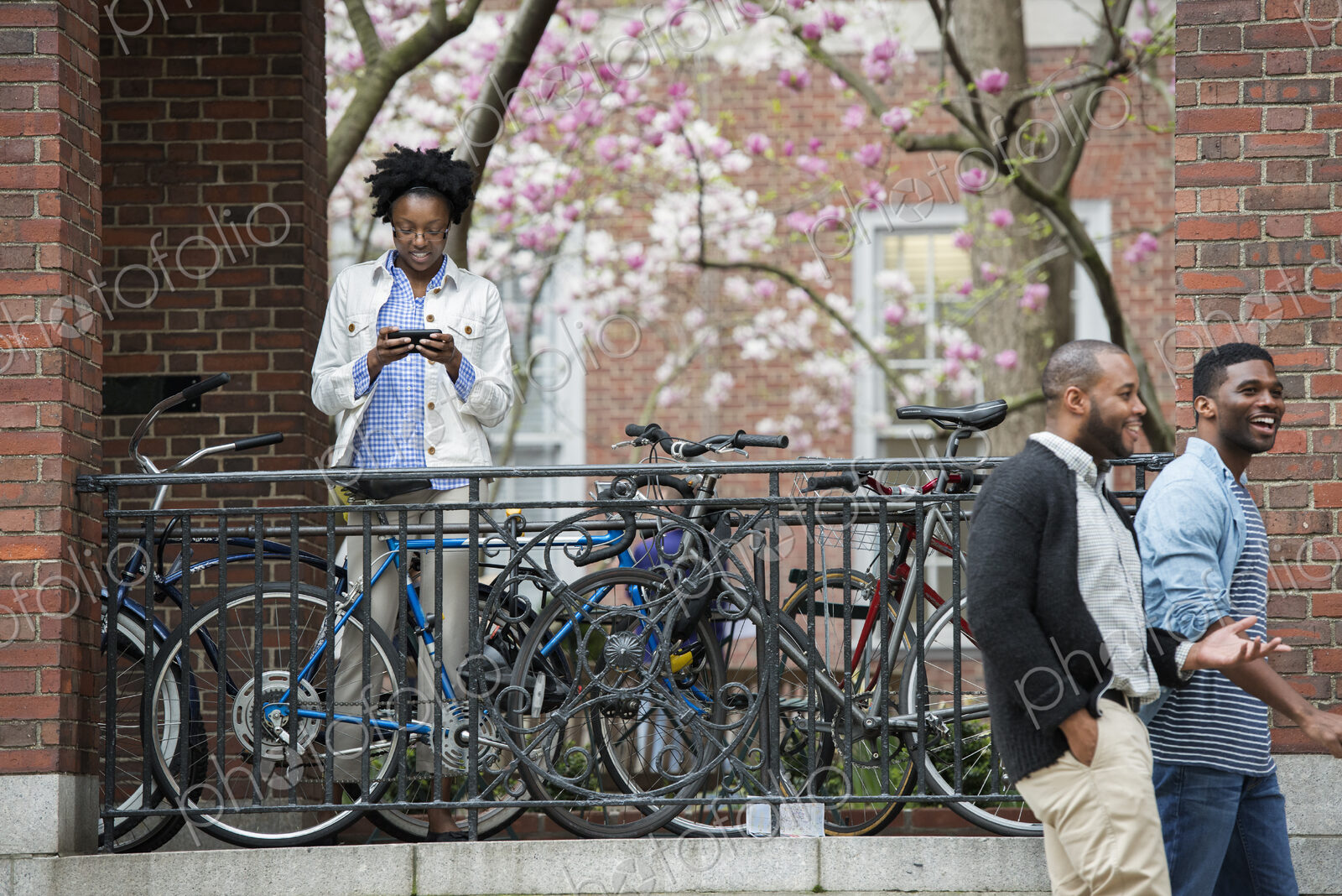 Outdoors in the city in spring. An urban lifestyle. A bicycle rack with locked…