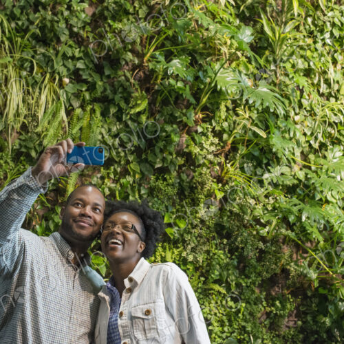 Outdoors in the city in spring. An urban lifestyle. A couple standing in front of a… Outdoors in the city in spring. An urban lifestyle. A couple standing in front of a…