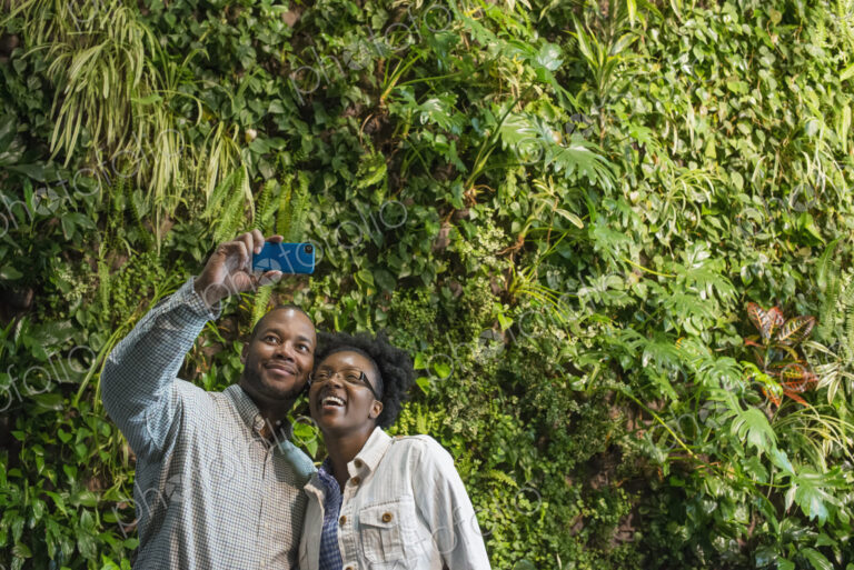 Outdoors in the city in spring. An urban lifestyle. A couple standing in front of a…