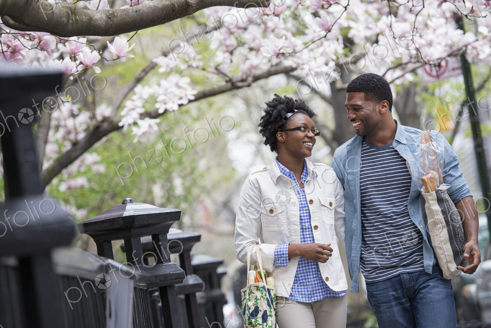 Outdoors in the city in spring. An urban lifestyle. A couple walking in the park side…