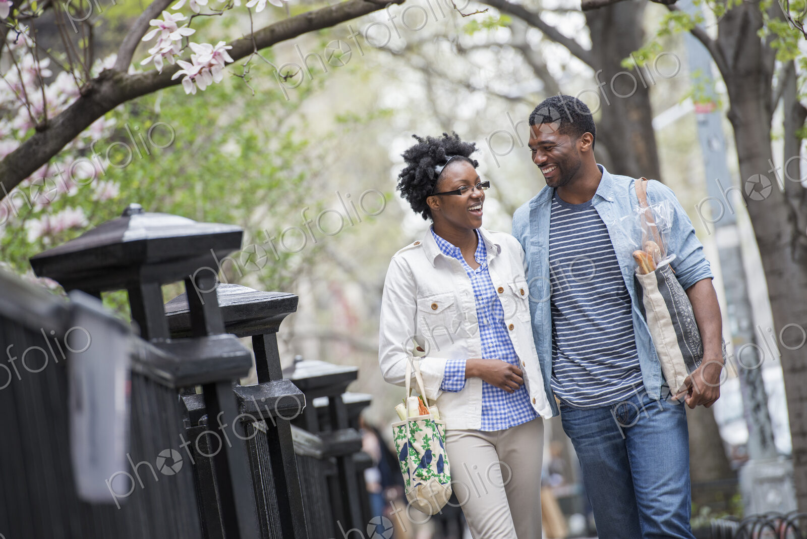 Outdoors in the city in spring. An urban lifestyle. A couple walking in the park side…
