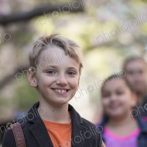 Outdoors in the city in spring. An urban lifestyle. A group of children on the… Outdoors in the city in spring. An urban lifestyle. A group of children on the…