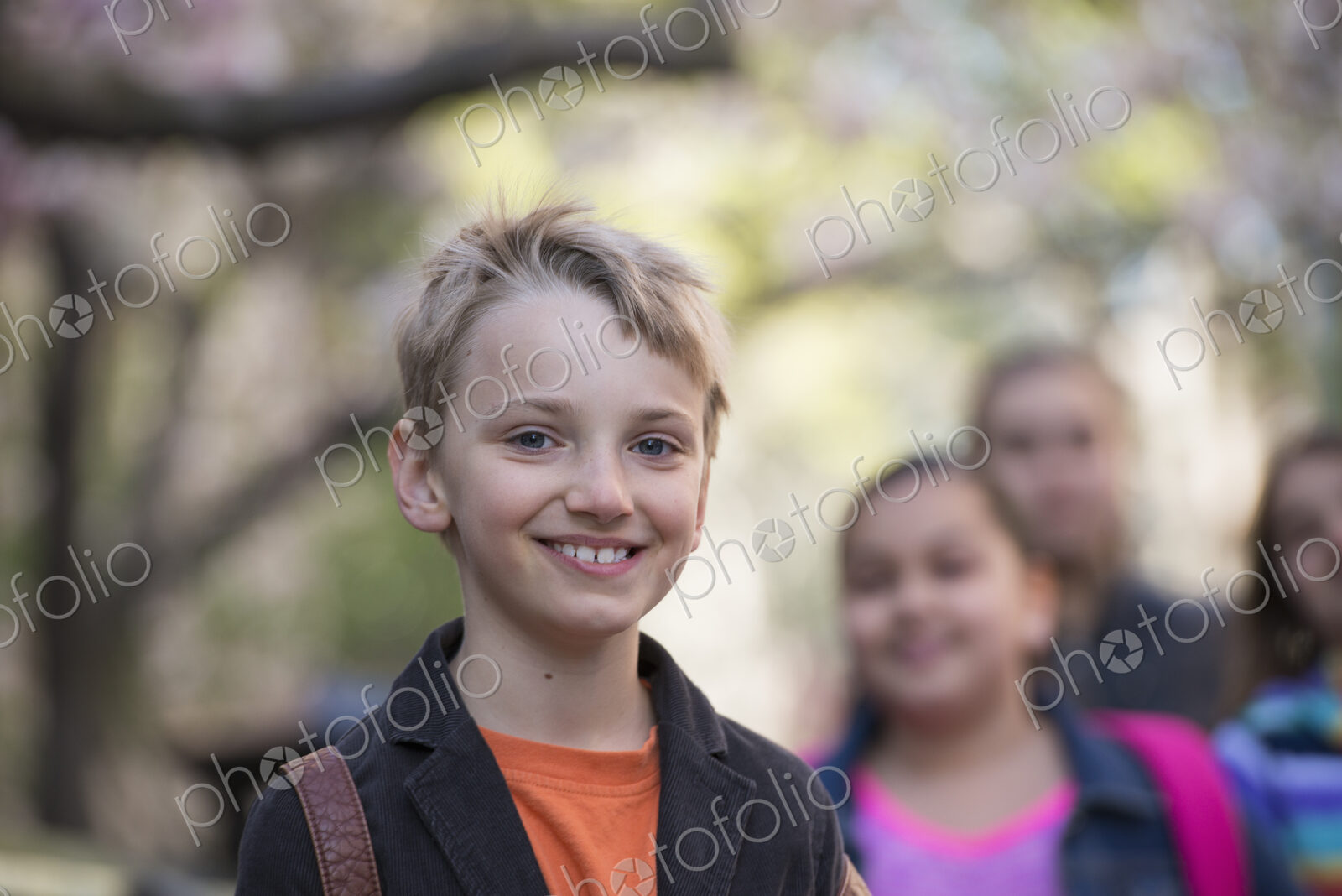 Outdoors in the city in spring. An urban lifestyle. A group of children on the…