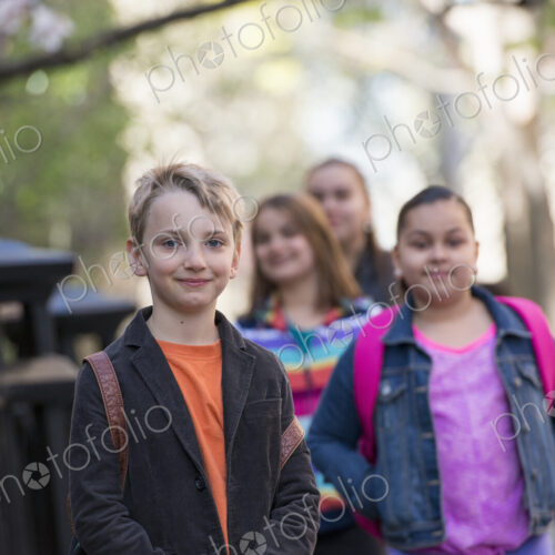 Outdoors in the city in spring. An urban lifestyle. A group of children on the… Outdoors in the city in spring. An urban lifestyle. A group of children on the…