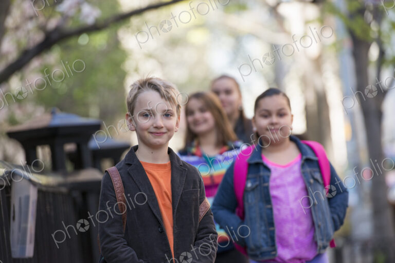 Outdoors in the city in spring. An urban lifestyle. A group of children on the…