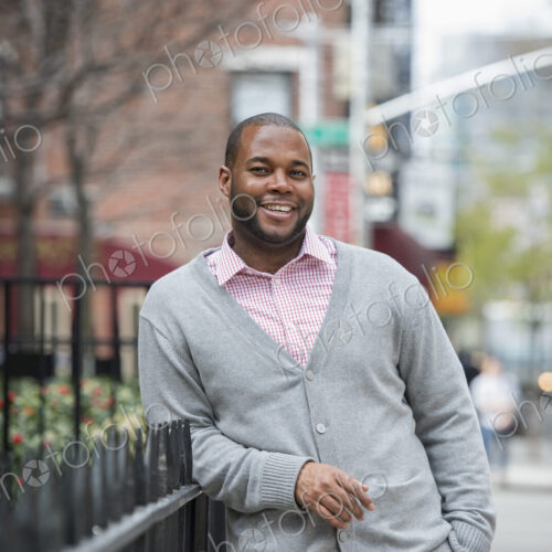 Outdoors in the city in spring. An urban lifestyle. A man leaning against a railing…