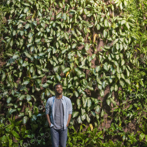Outdoors in the city in spring. An urban lifestyle. A man looking up at a high wall… Outdoors in the city in spring. An urban lifestyle. A man looking up at a high wall…