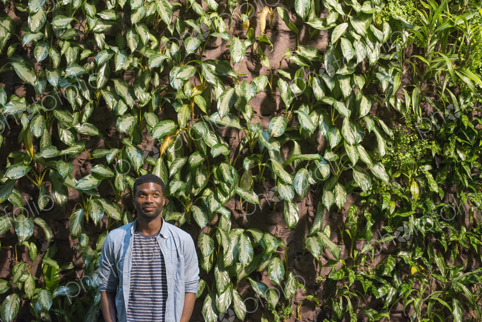 Outdoors in the city in spring. An urban lifestyle. A man standing in front of a wall…