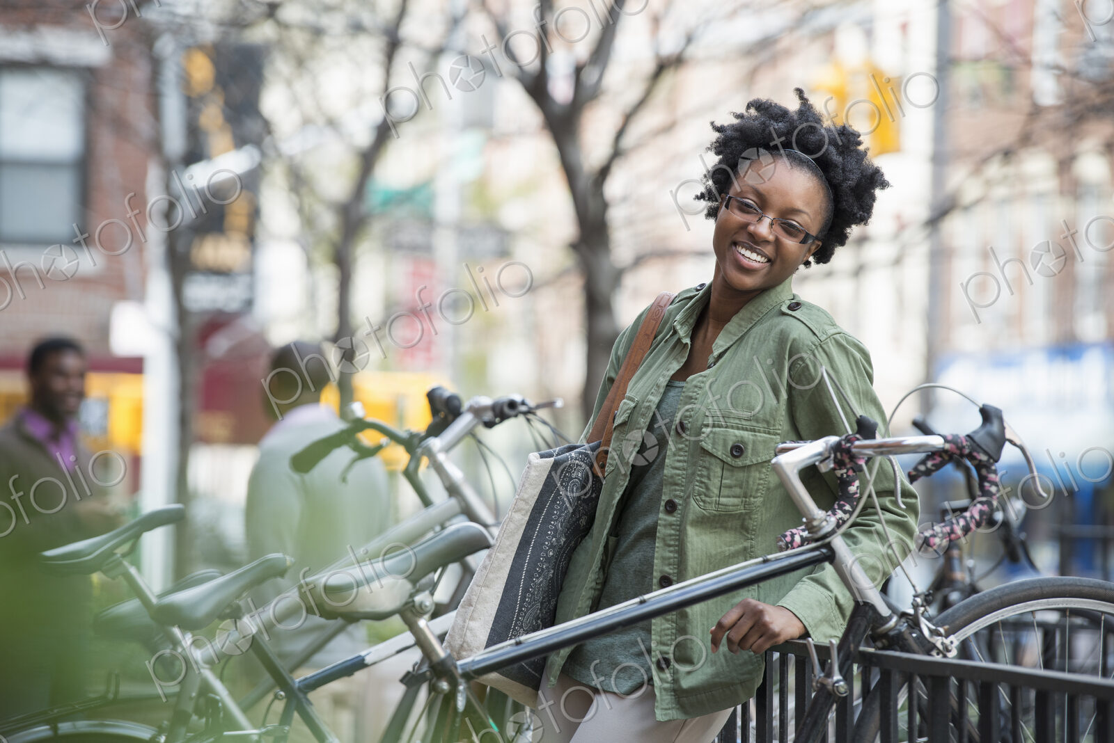 Outdoors in the city in spring. An urban lifestyle. A woman leaning against a railing…