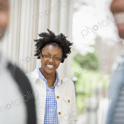 Outdoors in the city in spring. An urban lifestyle. A woman looking at the camera,…