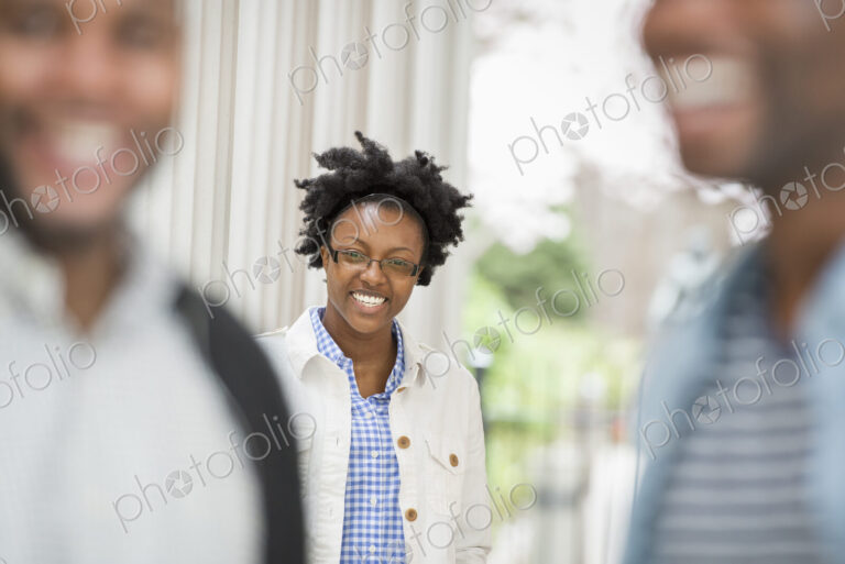 Outdoors in the city in spring. An urban lifestyle. A woman looking at the camera,…