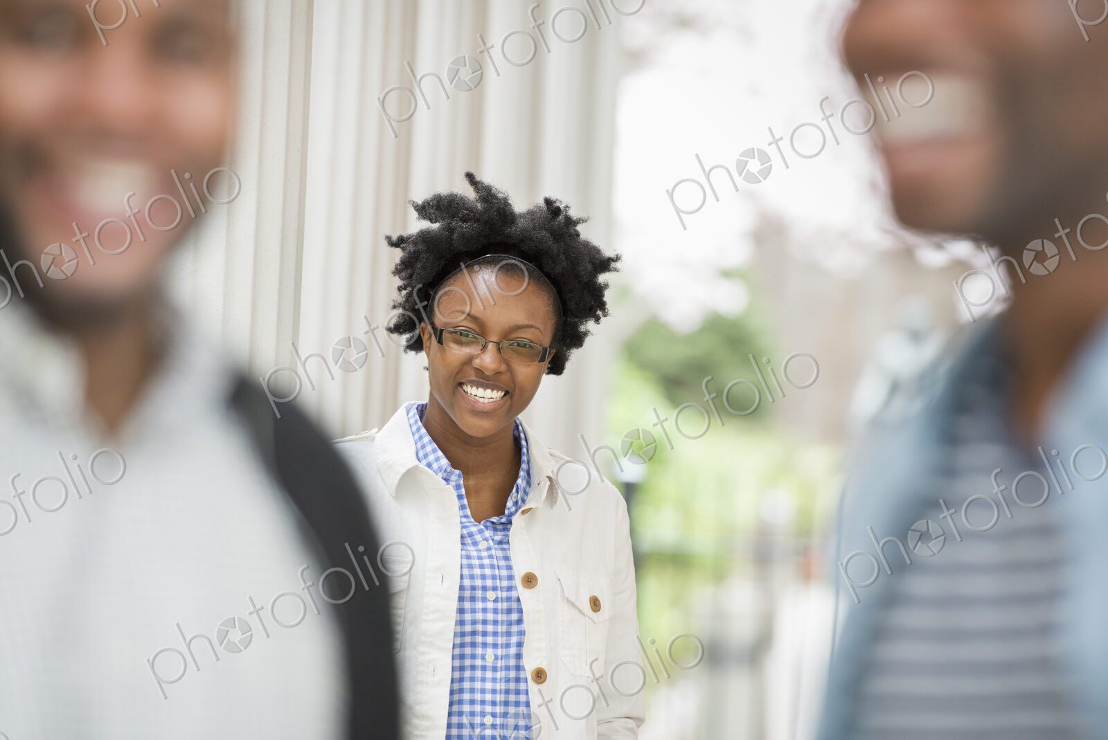 Outdoors in the city in spring. An urban lifestyle. A woman looking at the camera,…