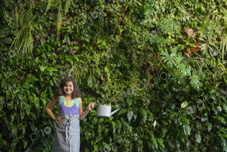 Outdoors in the city in spring. An urban lifestyle. A young girl standing in front of…
