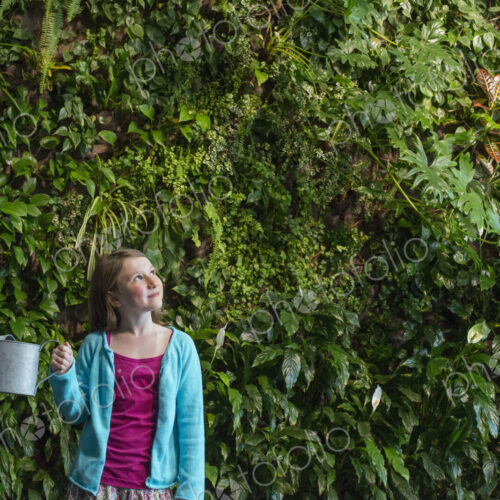 Outdoors in the city in spring. An urban lifestyle. A young girl standing in front of… Outdoors in the city in spring. An urban lifestyle. A young girl standing in front of…