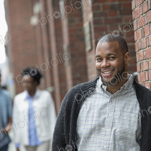 Outdoors in the city in spring. An urban lifestyle. Three people on the street. Outdoors in the city in spring. An urban lifestyle. Three people on the street.