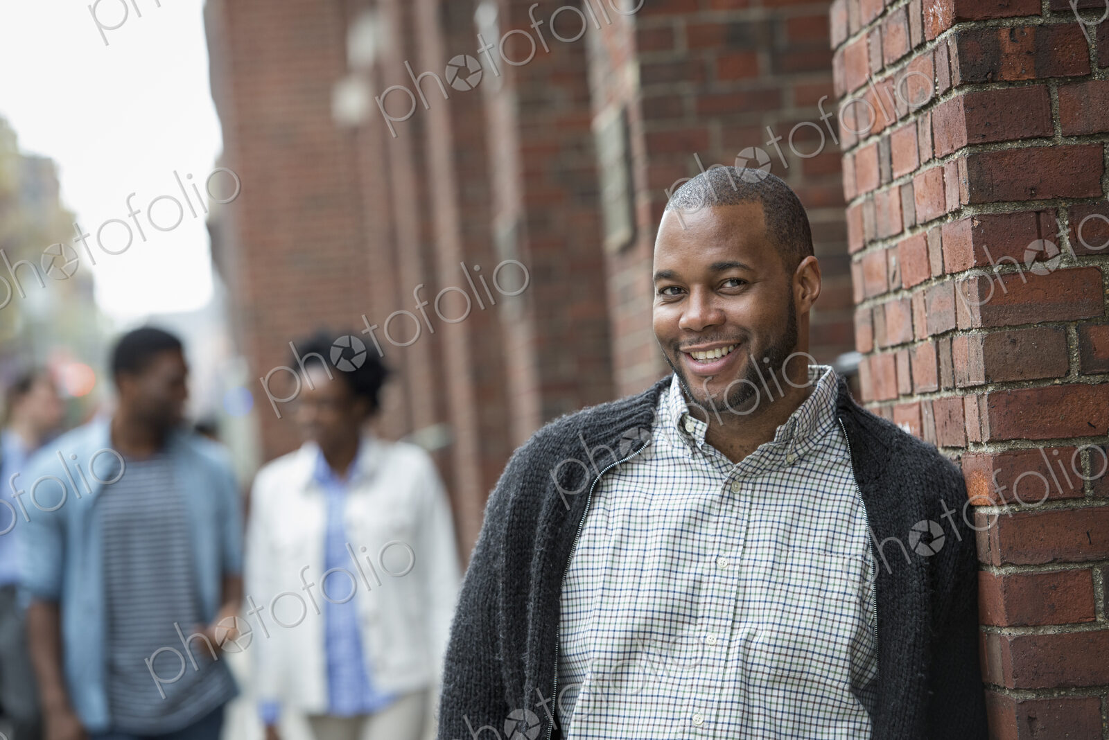 Outdoors in the city in spring. An urban lifestyle. Three people on the street.