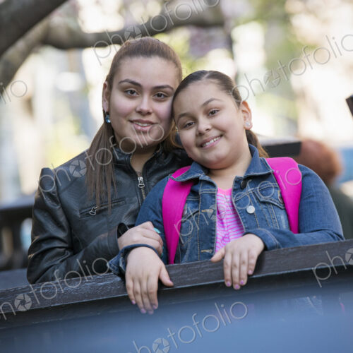 Outdoors in the city in spring. An urban lifestyle. Two children side by side, with… Outdoors in the city in spring. An urban lifestyle. Two children side by side, with…