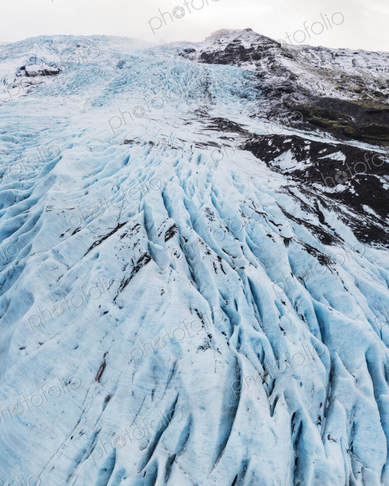 Overhead View of Falljokul Glacier, the frozen outlet of the vast Vatnajökull ice cap,…