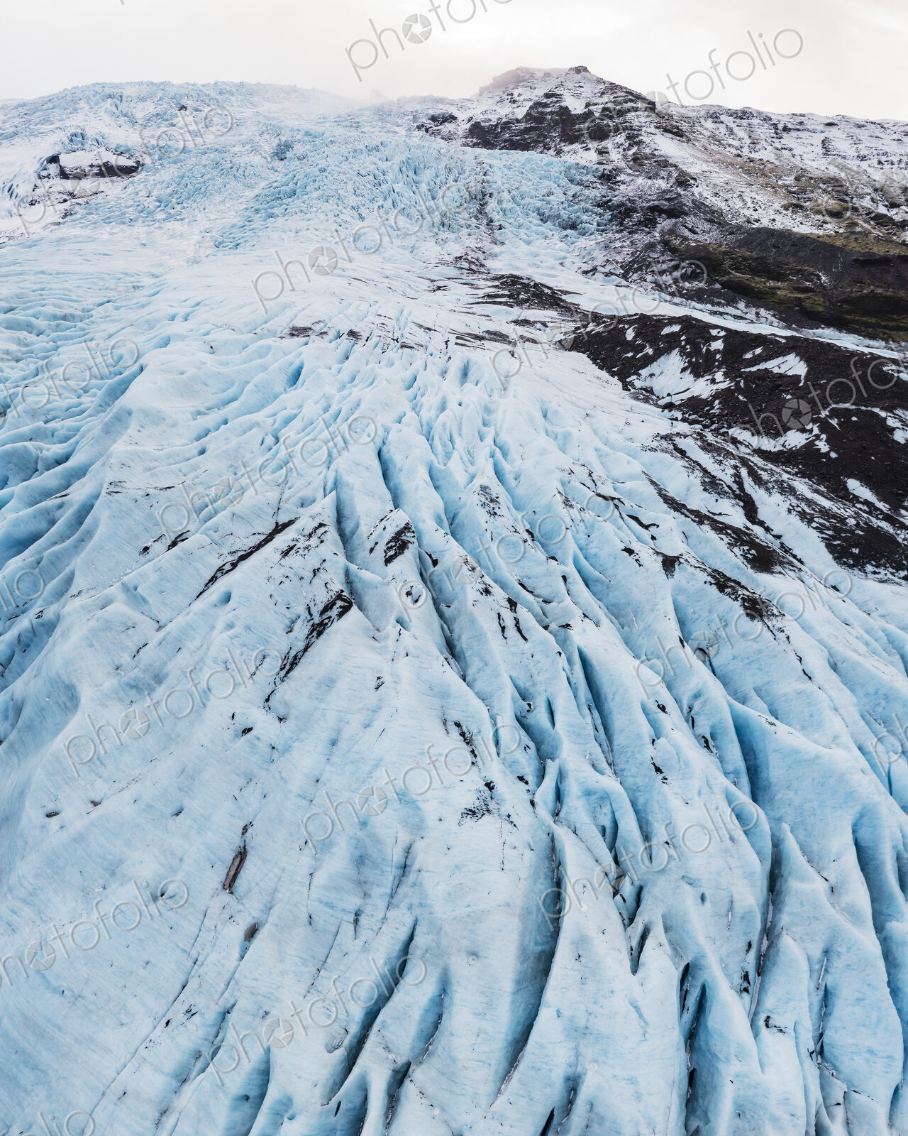 Overhead View of Falljokul Glacier, the frozen outlet of the vast Vatnajökull ice cap,…