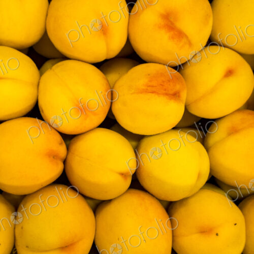 Overhead view of a box of peaches.