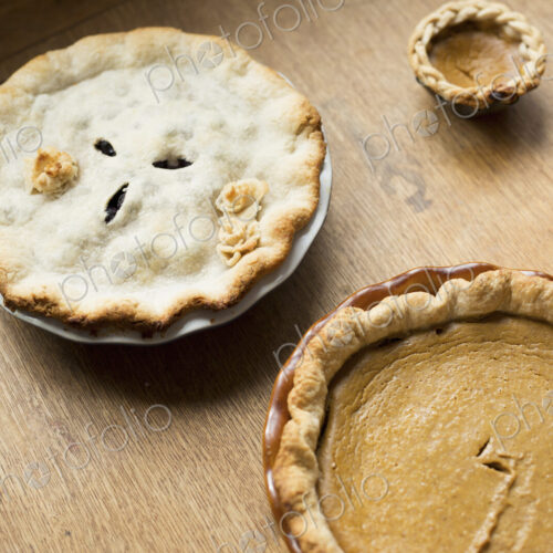 Overhead view of a freshly baked home made pie with pastry top and decoration. Overhead view of a freshly baked home made pie with pastry top and decoration.