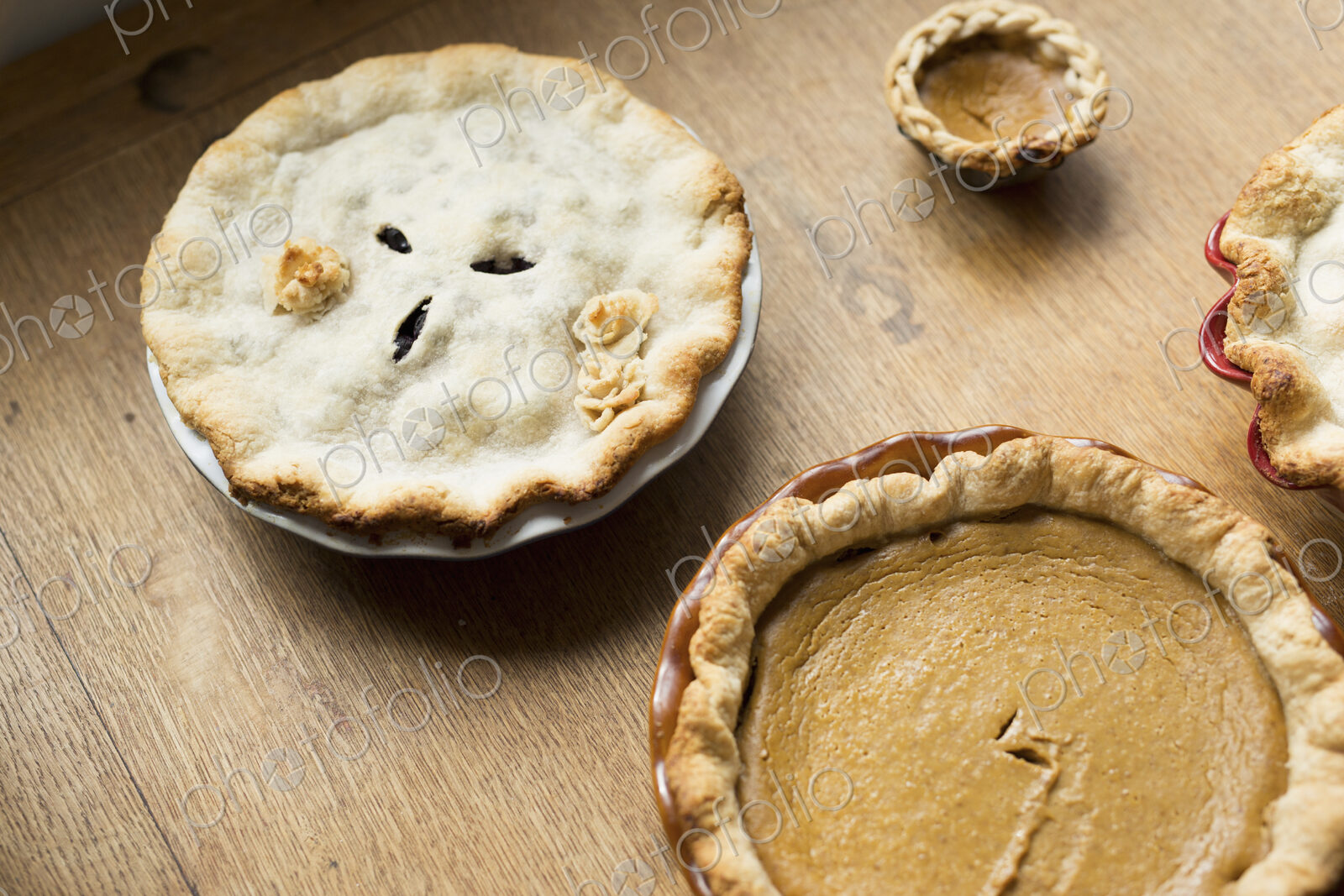 Overhead view of a freshly baked home made pie with pastry top and decoration.
