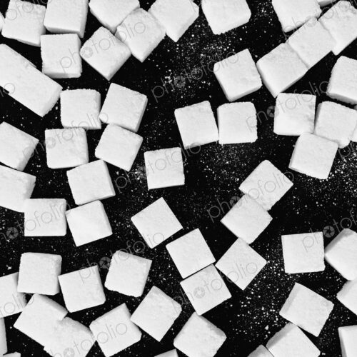 Overhead view of sugar cubes on black backdrop Overhead view of sugar cubes on black backdrop