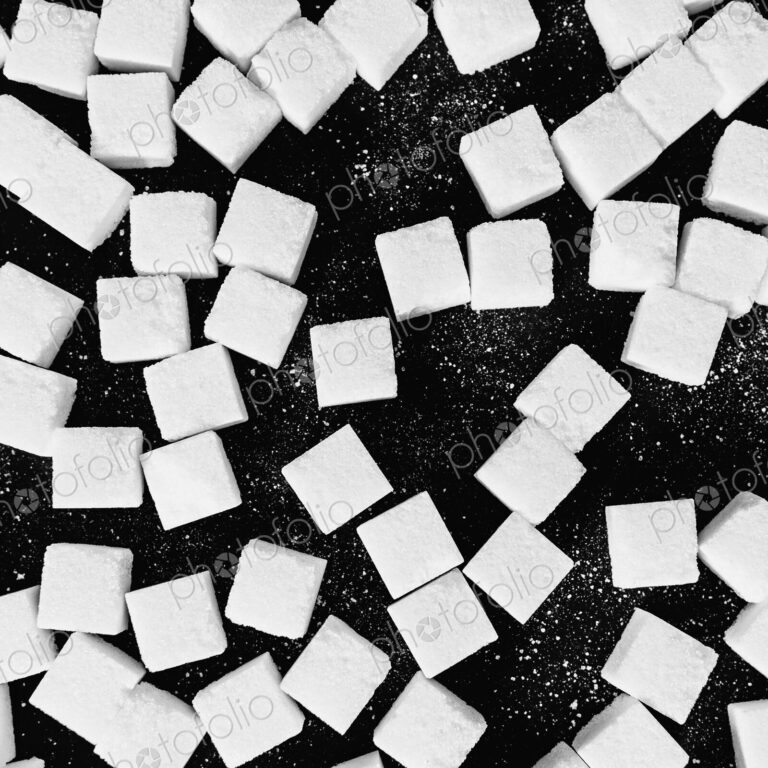 Overhead view of sugar cubes on black backdrop