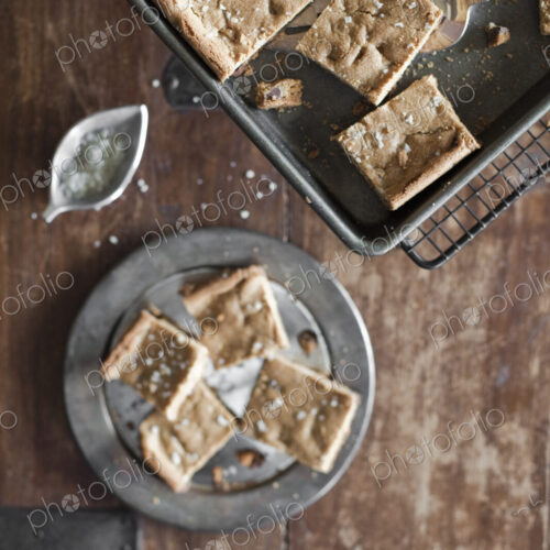 Overhead view. A tray bake, cake or biscuits cut into squares. Organic food. Overhead view. A tray bake, cake or biscuits cut into squares. Organic food.