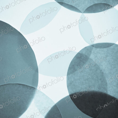 Overlapping circular shapes in various shades of blue.