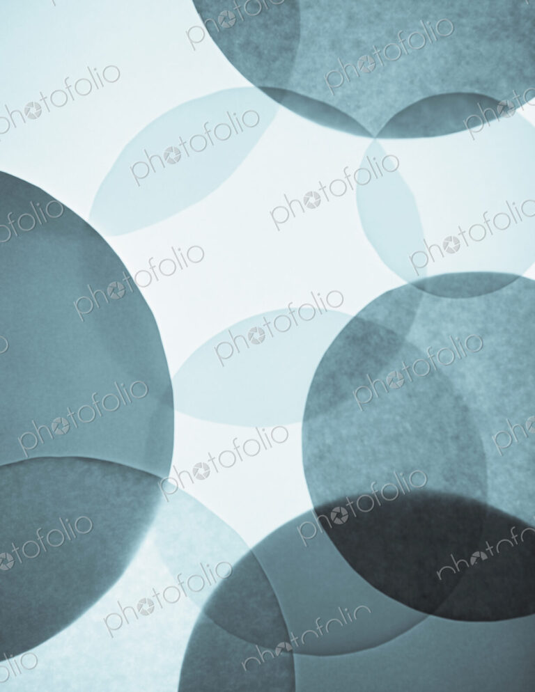 Overlapping circular shapes in various shades of blue.