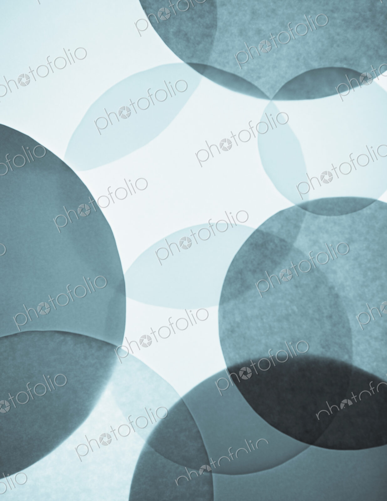 Overlapping circular shapes in various shades of blue.
