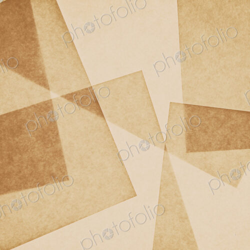 Overlapping pieces of recycled paper.