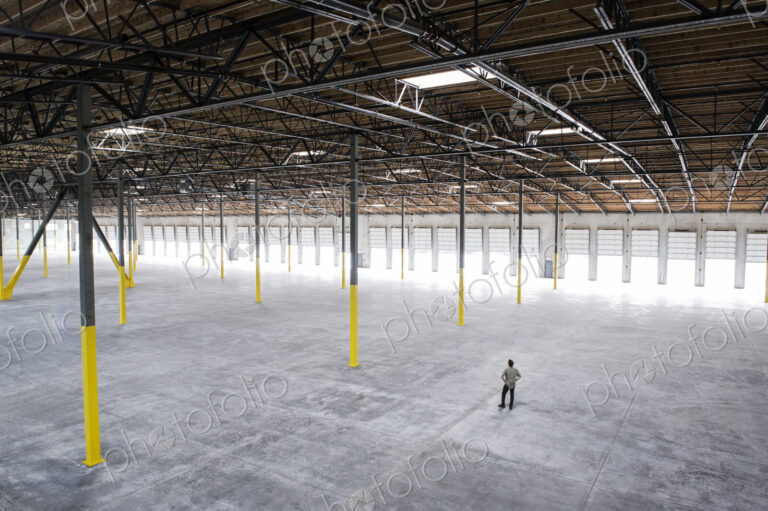 Owner checking out the new interior of a large empty warehouse space.