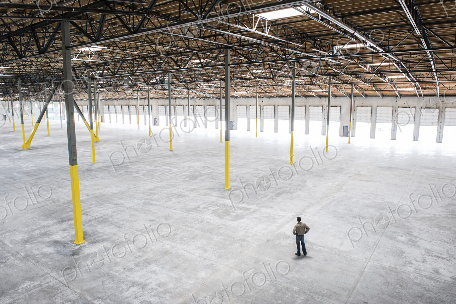 Owner checking out the new interior of a large empty warehouse space.