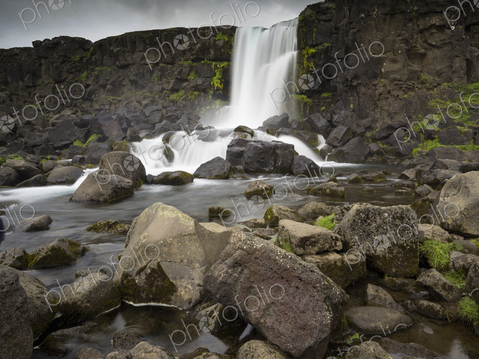 Oxararfoss in Pingvellir National Park, waterfall cascading over a sheer cliff.