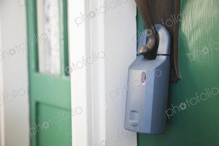 Padlock on front door with unsecured door.