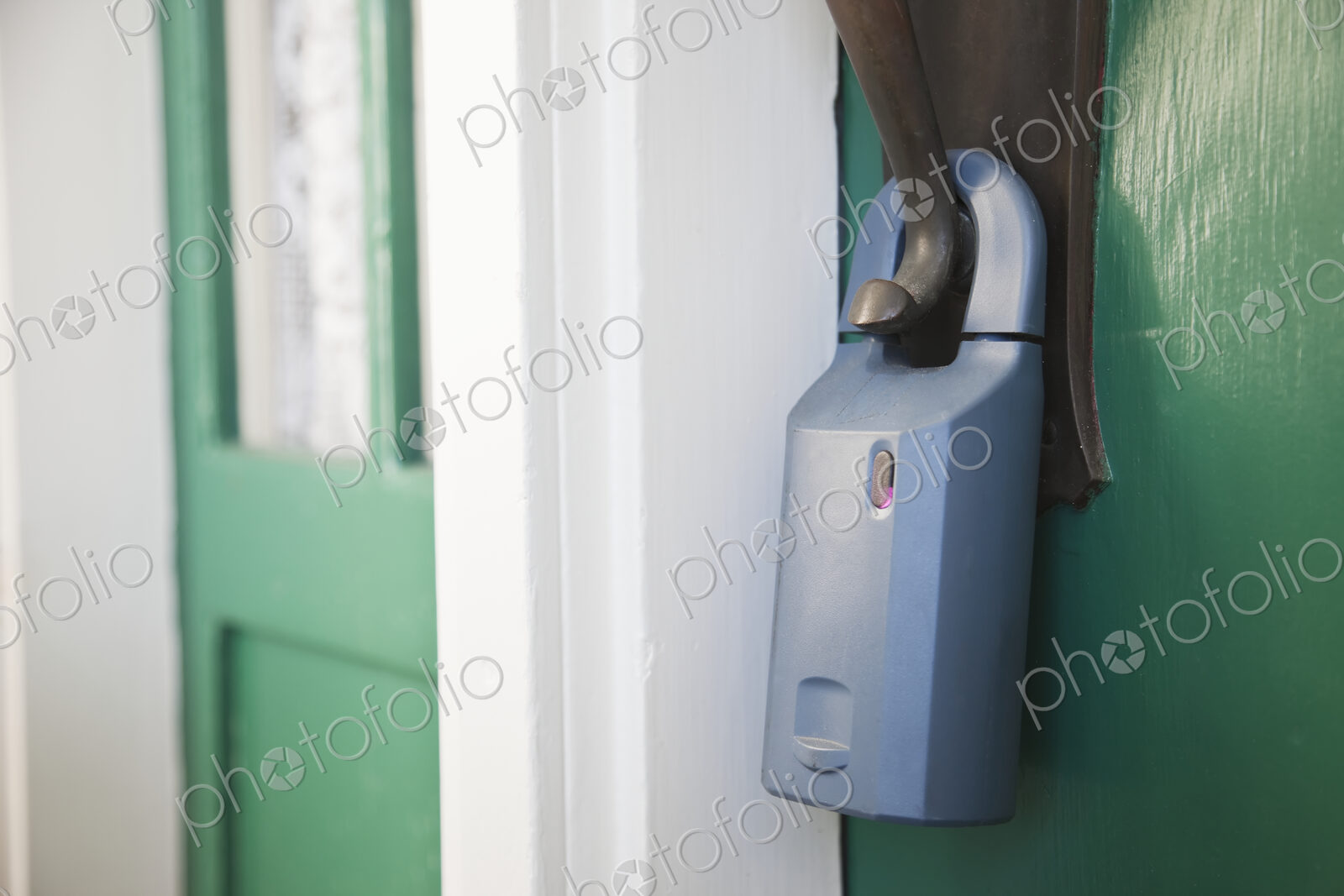 Padlock on front door with unsecured door.