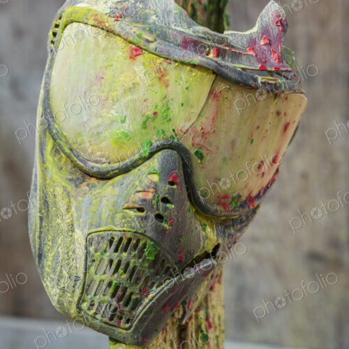 Paintball mask covered in paint at paintball field, Oregon, USA. Paintball mask covered in paint at paintball field, Oregon, USA.