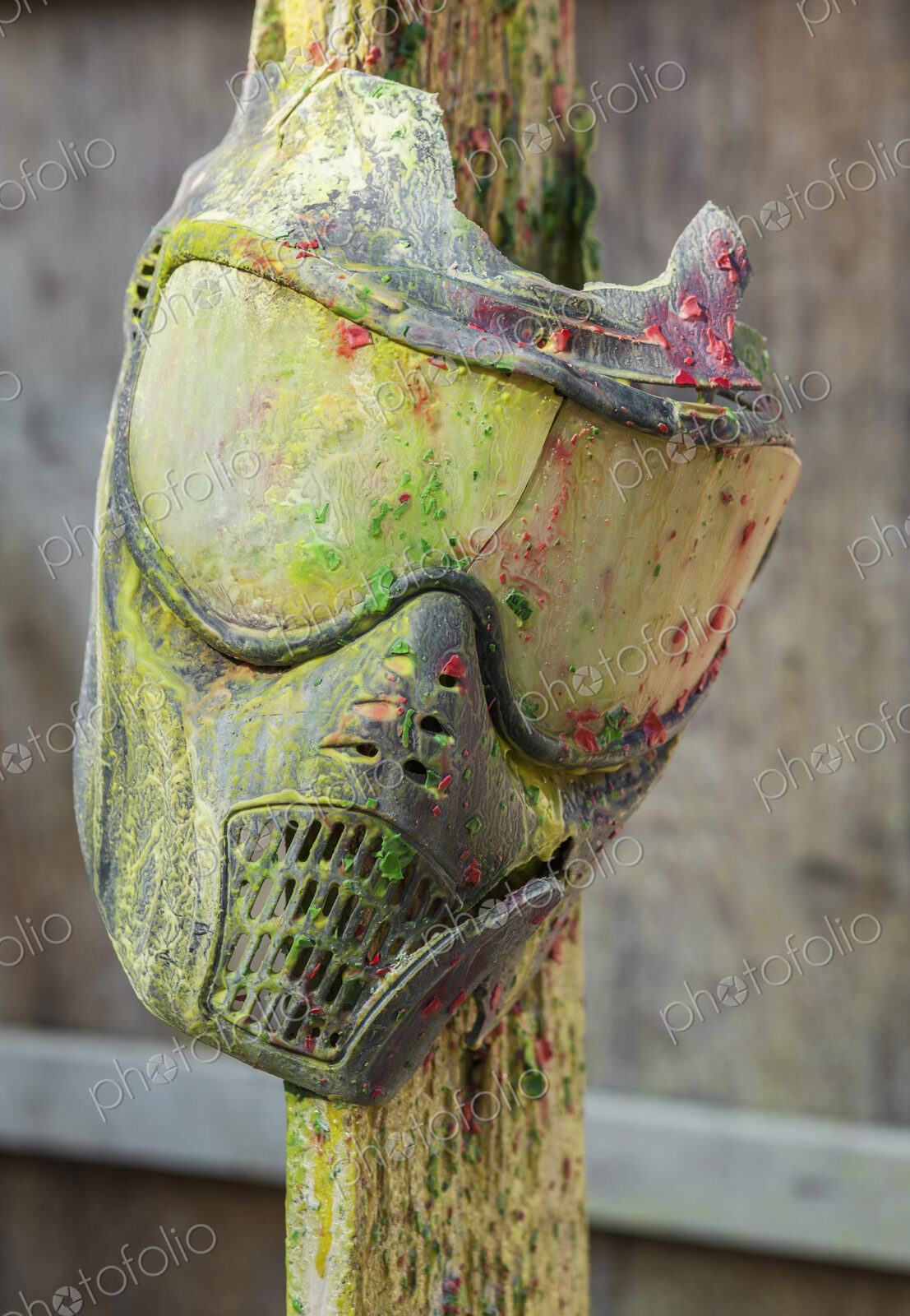 Paintball mask covered in paint at paintball field, Oregon, USA.