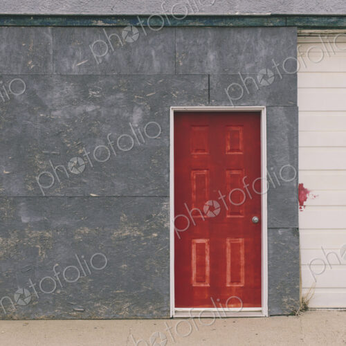 Painted red door and garage exterior, near Robsart, Saskatchewan, Canada. Painted red door and garage exterior, near Robsart, Saskatchewan, Canada.