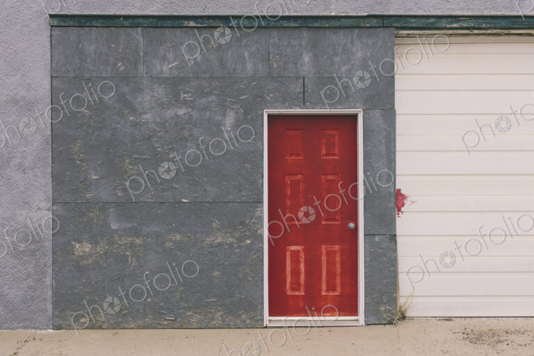 Painted red door and garage exterior, near Robsart, Saskatchewan, Canada.