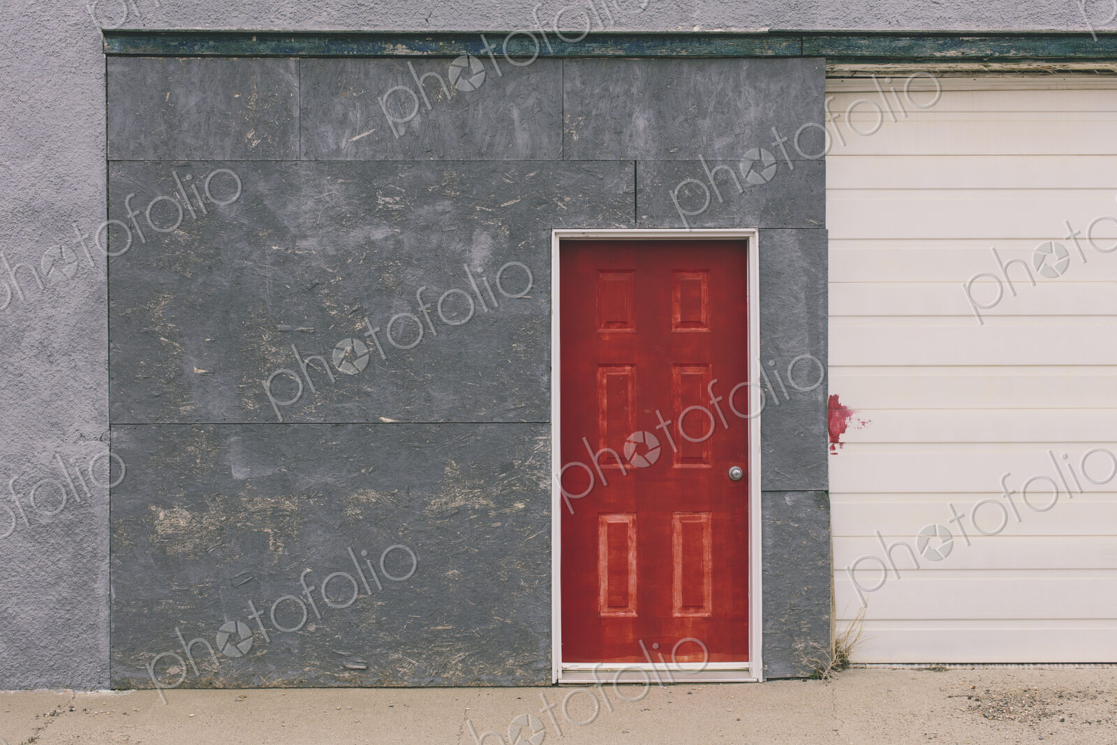 Painted red door and garage exterior, near Robsart, Saskatchewan, Canada.