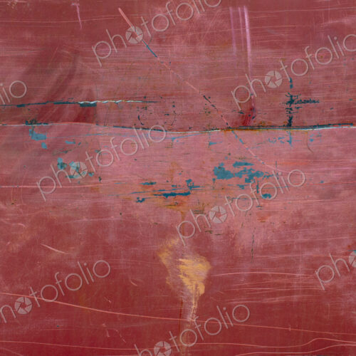 Painted red metal with rust and scratch markings
