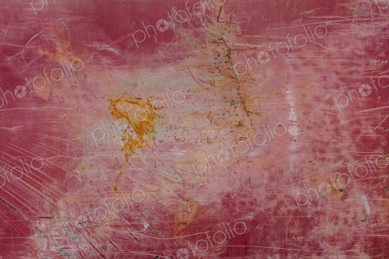 Painted red metal with rust and scratch markings