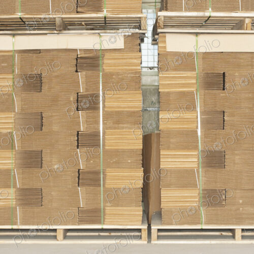 Pallets of flat folded cardboard boxes. Pallets of flat folded cardboard boxes.
