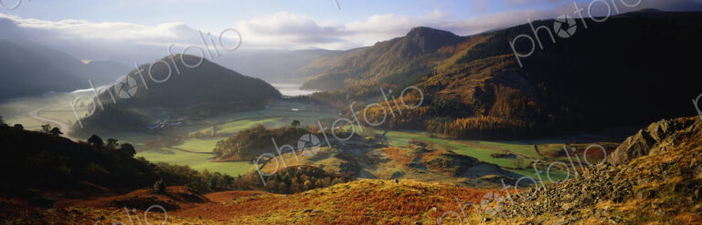 Panoramic landscape with valley and mountains.