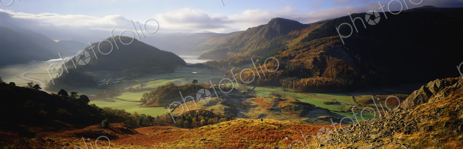 Panoramic landscape with valley and mountains.