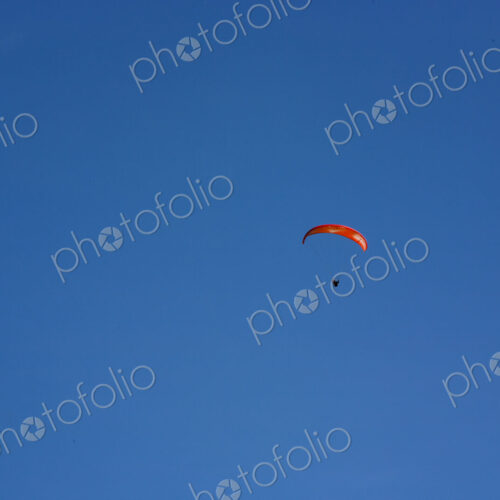 Paraglider above Yakima Canyon with a colourful canopy floating in a blue sky. Paraglider above Yakima Canyon with a colourful canopy floating in a blue sky.